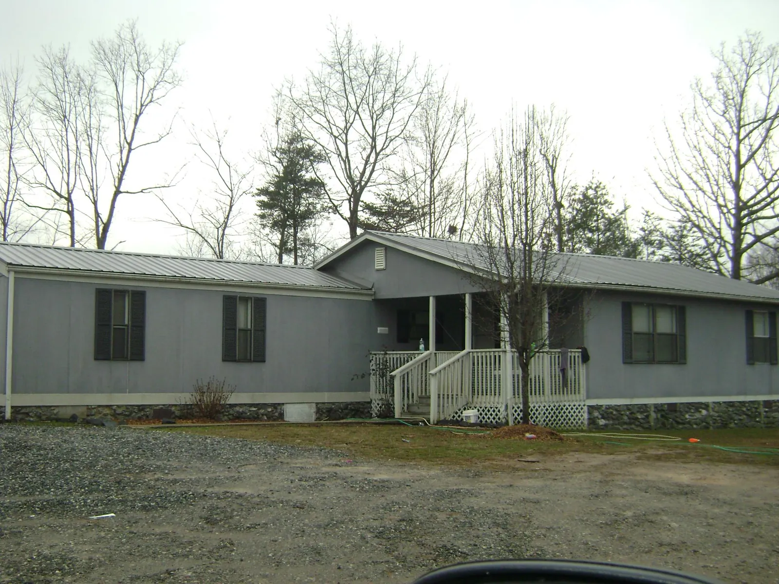 Metal roof over a manufactured home with a covered front porch in Caryville